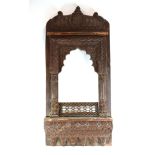 A Indian architectural carved wood panel of traditional arched form, h.