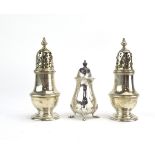 A pair of miniature silver sugar dredgers of typical form, maker C&FC, London 1925, h.