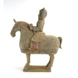 A painted Tang figure modelled as a horse and warrior wearing a lions mask headdress,