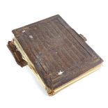 A Victorian family photograph album with a bark door design binding