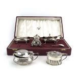A silver three piece cruet set, Birmingham 1966, cased, together with two further silver mustards,