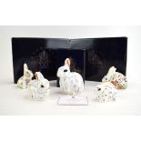 Five Royal Crown Derby paperweights, each in the form of a rabbit,