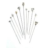 Eleven silver and metalware hat pins,