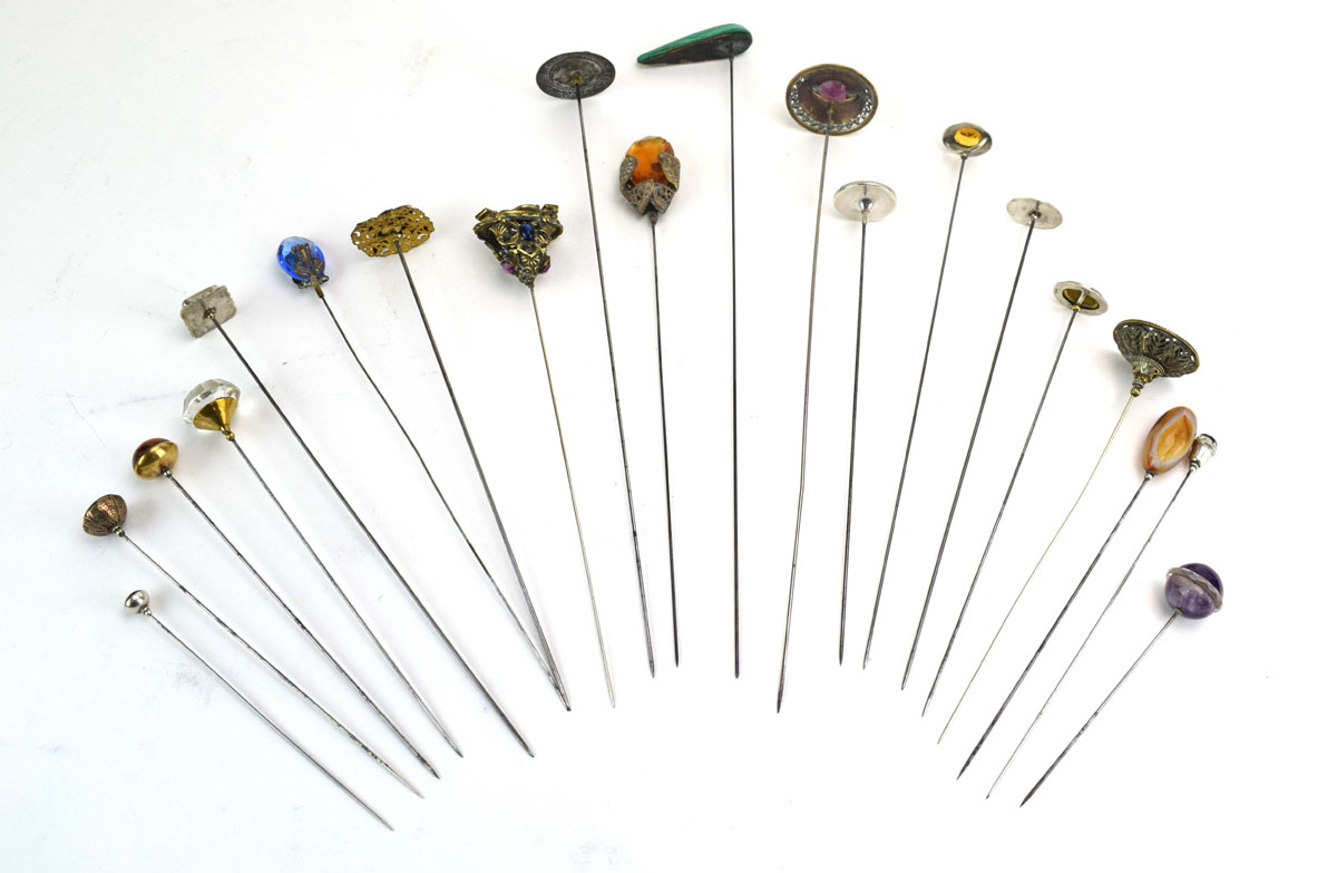 Twenty silver and metalware hat pins including hardstone and glass set examples, max l. 29.
