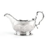 An early 20th century silver sauce boat of typical form with c-scroll handle, maker D&DS,