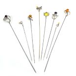 Eight silver and metalware hat pins,