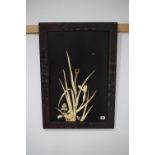 An Oriental black lacquered wall panel relief decorated with bone rushes,