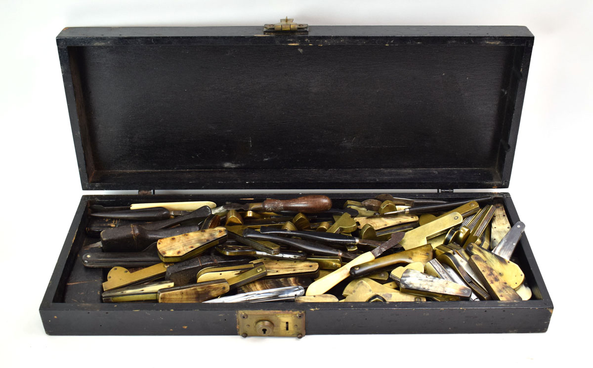 A black case containing an extensive group of 19th century phlebotomy blood letting tools,