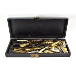 A black case containing an extensive group of 19th century phlebotomy blood letting tools,