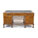 A Queen Anne-style breakfront desk,