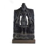 An Indian black stone carving modelled as Vishnu and her attendants on a double lotus base,