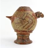 A Pre-Columbian pottery jar of ovoid form with stylised birds head/tail handles and painted in