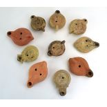Ten Roman oil lamps, each decorated with figural and other designs, max l.