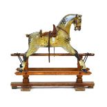 A late 19th century polychrome rocking horse with a leather saddle and tack on a pine base