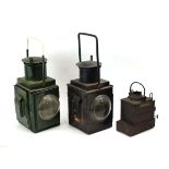 A BR(M) railway lantern together with a similar green lantern and a smaller light