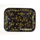 A Victorian black lacquered papier mache tray with gilt floral decoration,