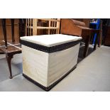 Pine trunk upholstered in cream vinyl