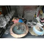 A cage containing: wine glasses, studio pottery bowl, children's toys, glass fruit bowls and