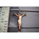 (9) Hand painted plaster figure of the crucifix on wrought iron cross