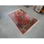 Red ground floral patterned rug