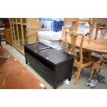 Modern black finish television cabinet with 1980s tubular metal side table