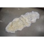 White and grey tipped sheepskin carpet, approx. 180cm x 70cm