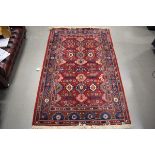 (11) Louis De Poortere Karabagh carpet with red ground and geometric pattern, approx. 140cm x 220cm