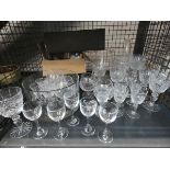 A cage containing: a large quantity of tumblers, brandy snifters, sherry glasses and wine glasses