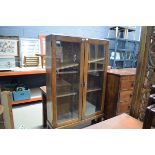 1930s oak display cabinet with glazed doors and cup and cover legs