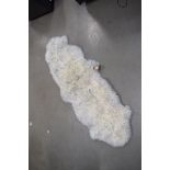 White and grey tipped sheepskin rug, approx. 180cm x 60cm