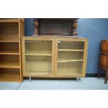 Oak glazed bookcase on modern chrome legs