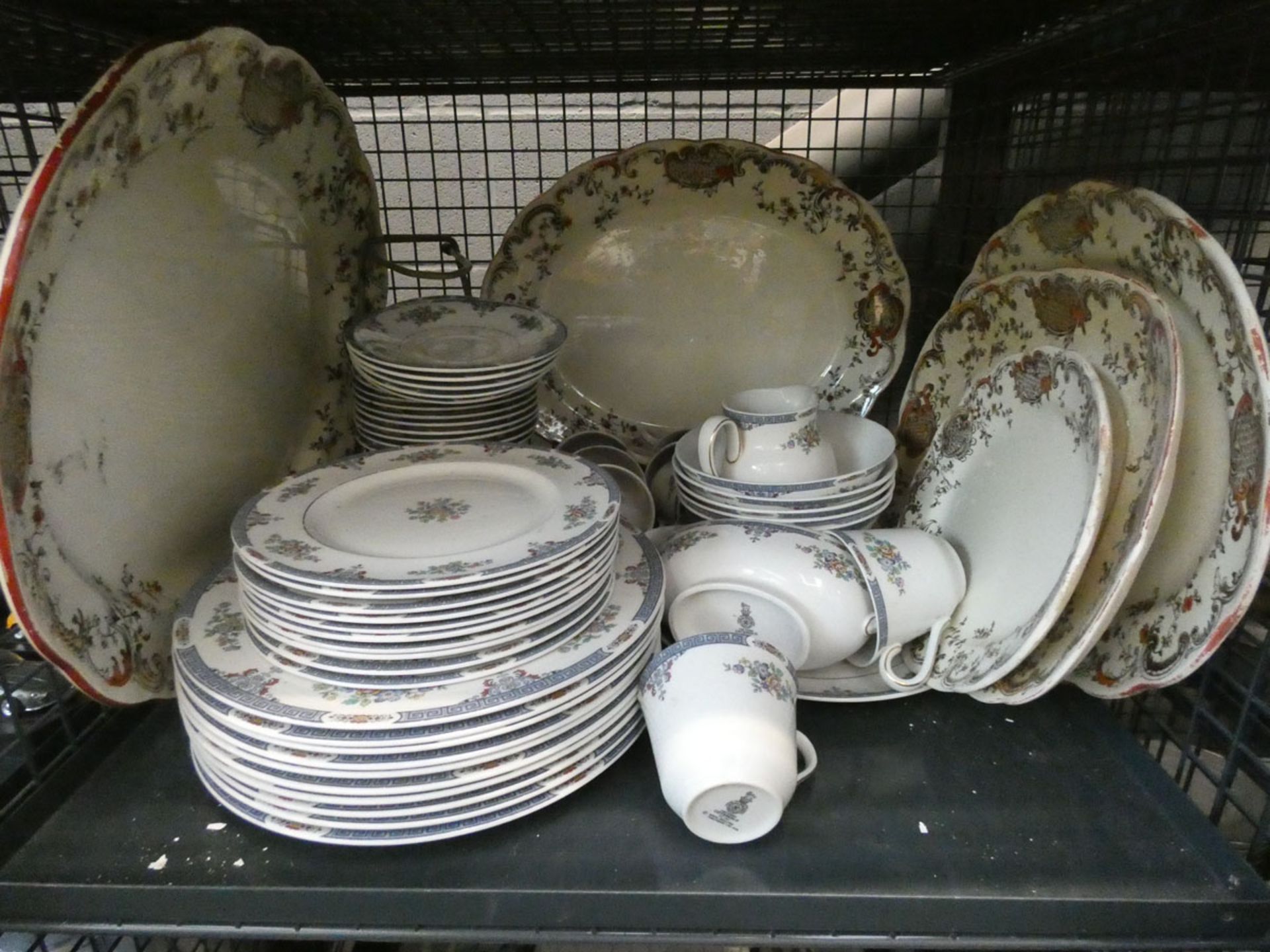 A cage containing a quantity of Royal Doulton Cotswold pattern crockery