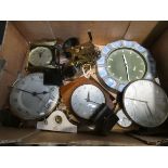 A box containing a quantity of clocks and clock movements