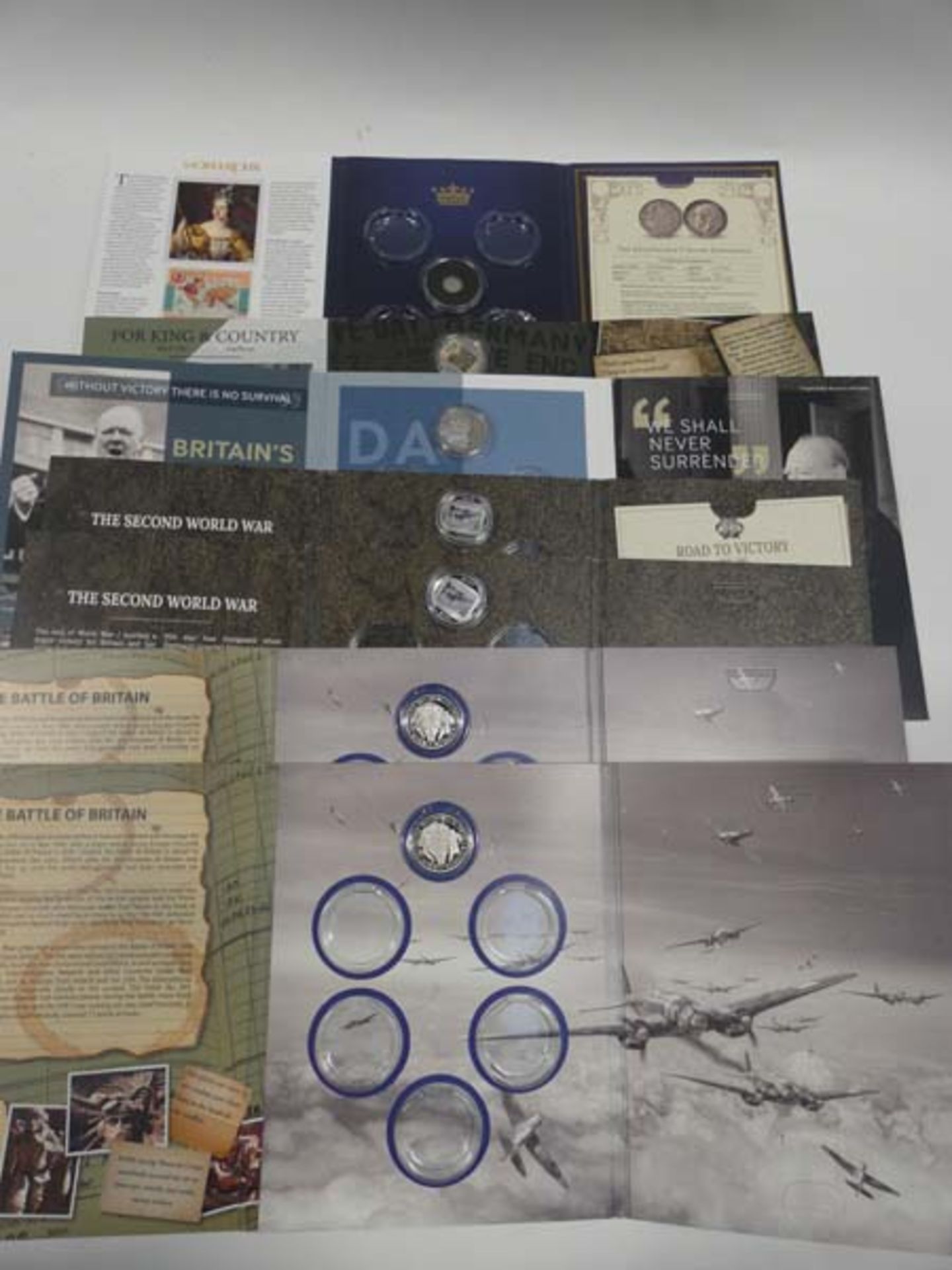 Selection of collectable coin starter sets; Monarchs, Road to Victory, VE Day Chronicle, Darkest