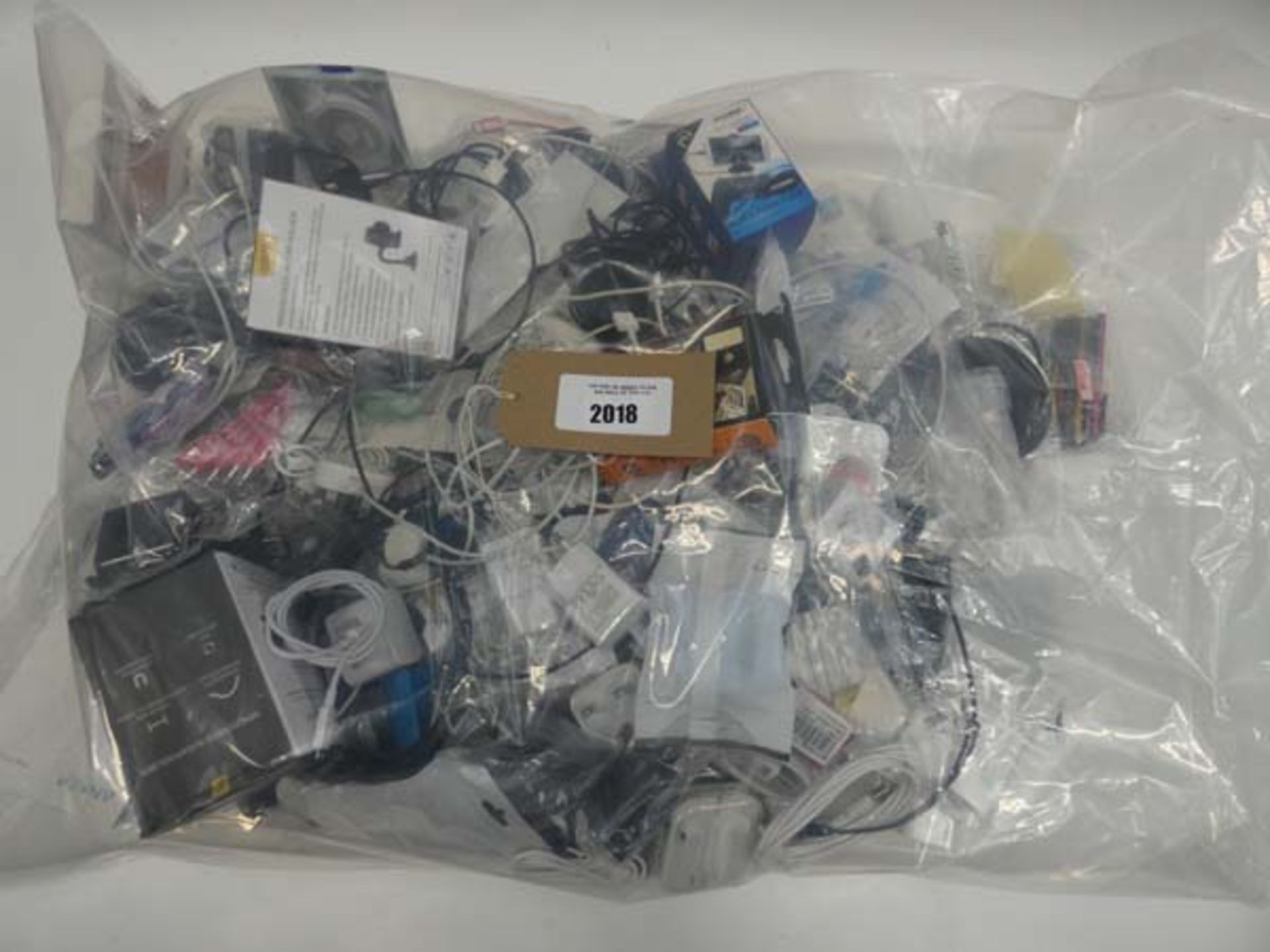 Bag containing quantity of mobile phone accessories; adapters, leads, headphones, stands etc