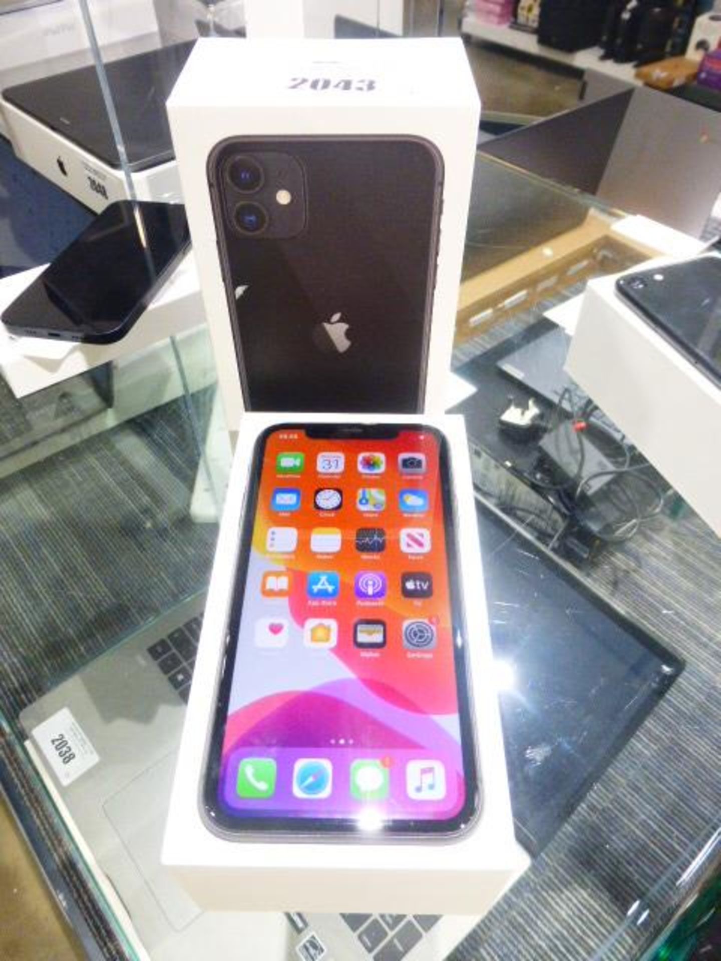 Apple iPhone 11 in black. 64GB mobile phone. Comes with charger, earphones and box