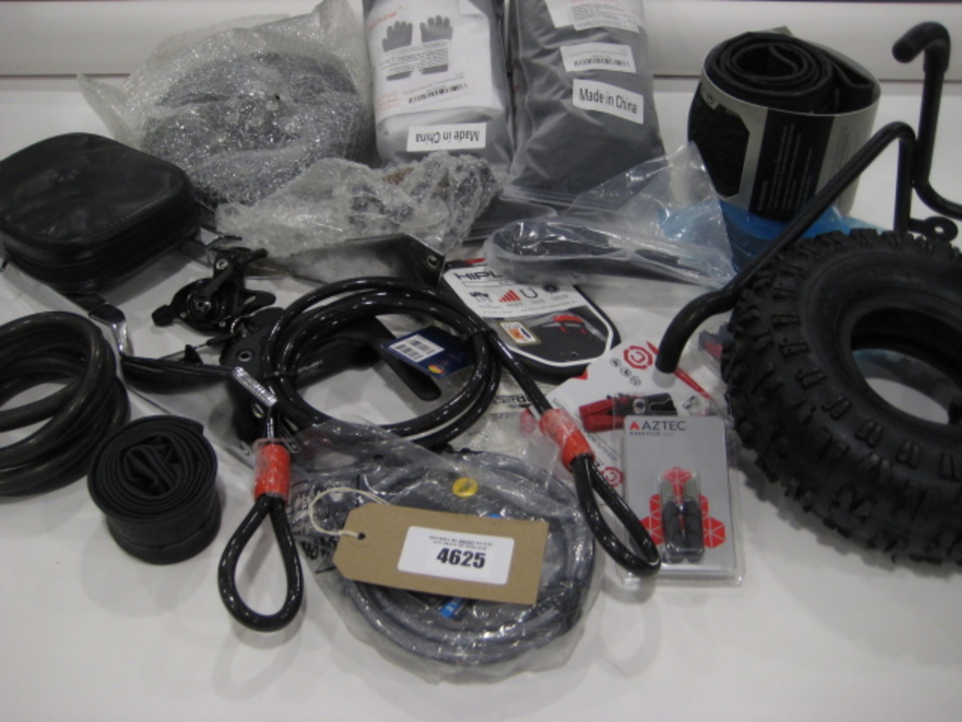 Bag containing bike and motorbike parts including tyres, locks, brake levers, racks, seats, inner