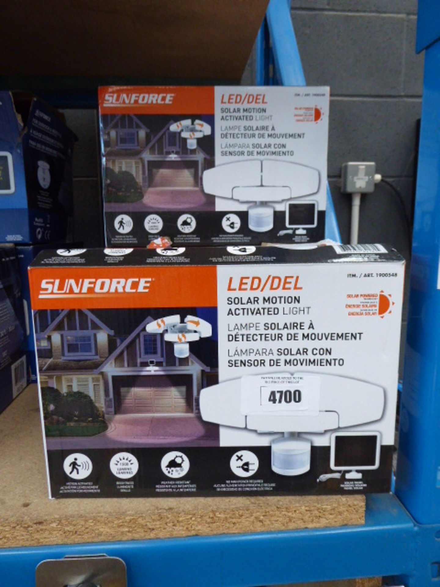 5 Sunforce LED solar motion lights in orange and white boxes