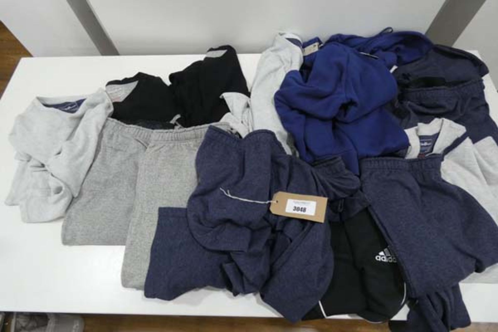 Bag containing mens jogging and sleep wear including Adidas hoodie and Eddie Bauer sleep wear in