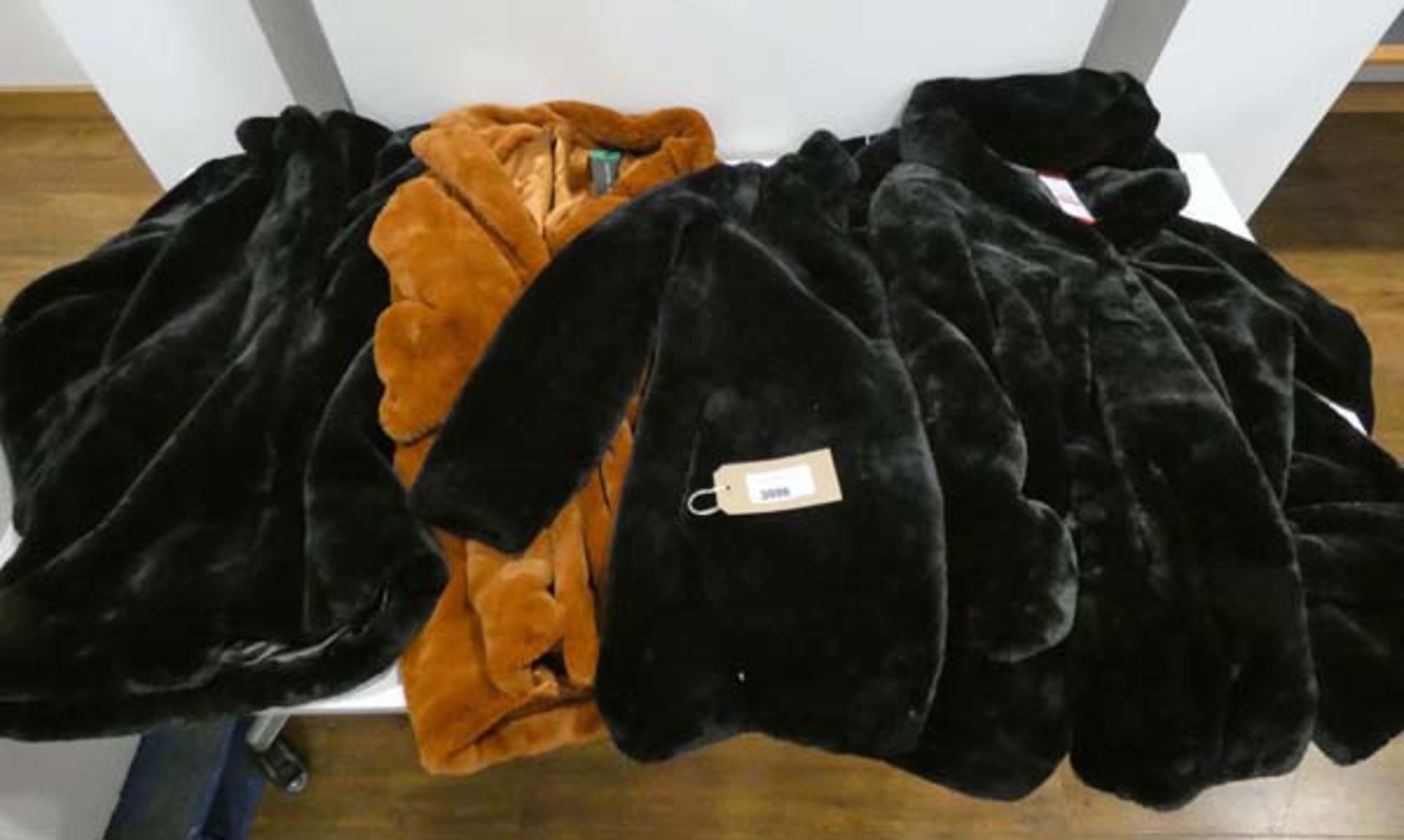 4 ladies faux fur coats to include DKNY and Andrew Marc, 3 in black and 1 in rusty brown, the 3