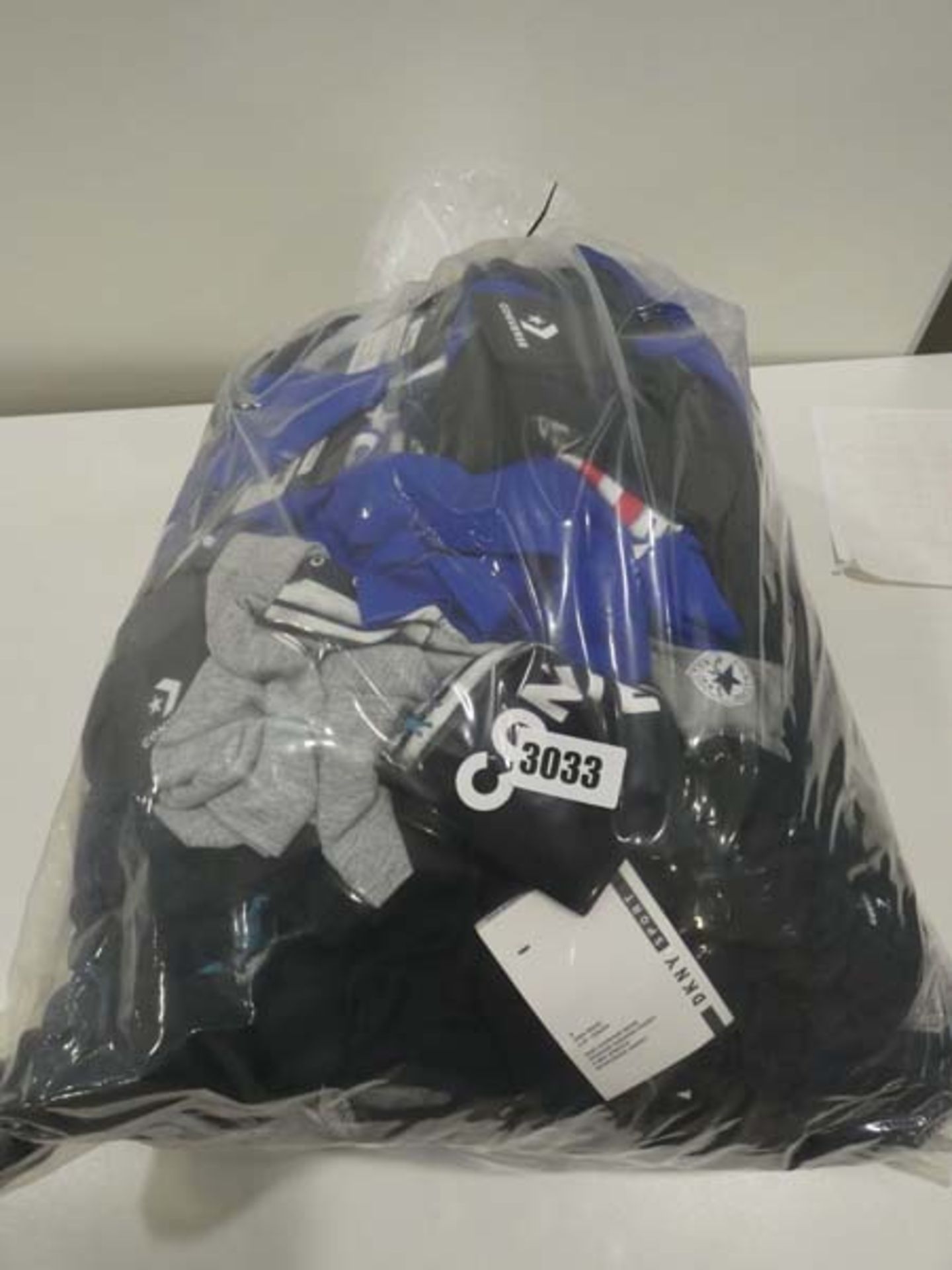 Bag containing childrens Converse tops in various sizes, colours of blue, black and grey