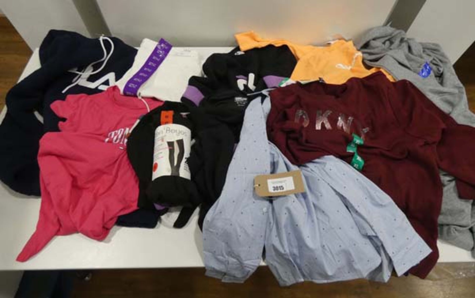 Bag containing mixed ladies clothing including Champion tops, Fila hoodie, DKNY top, Jessica Simpson