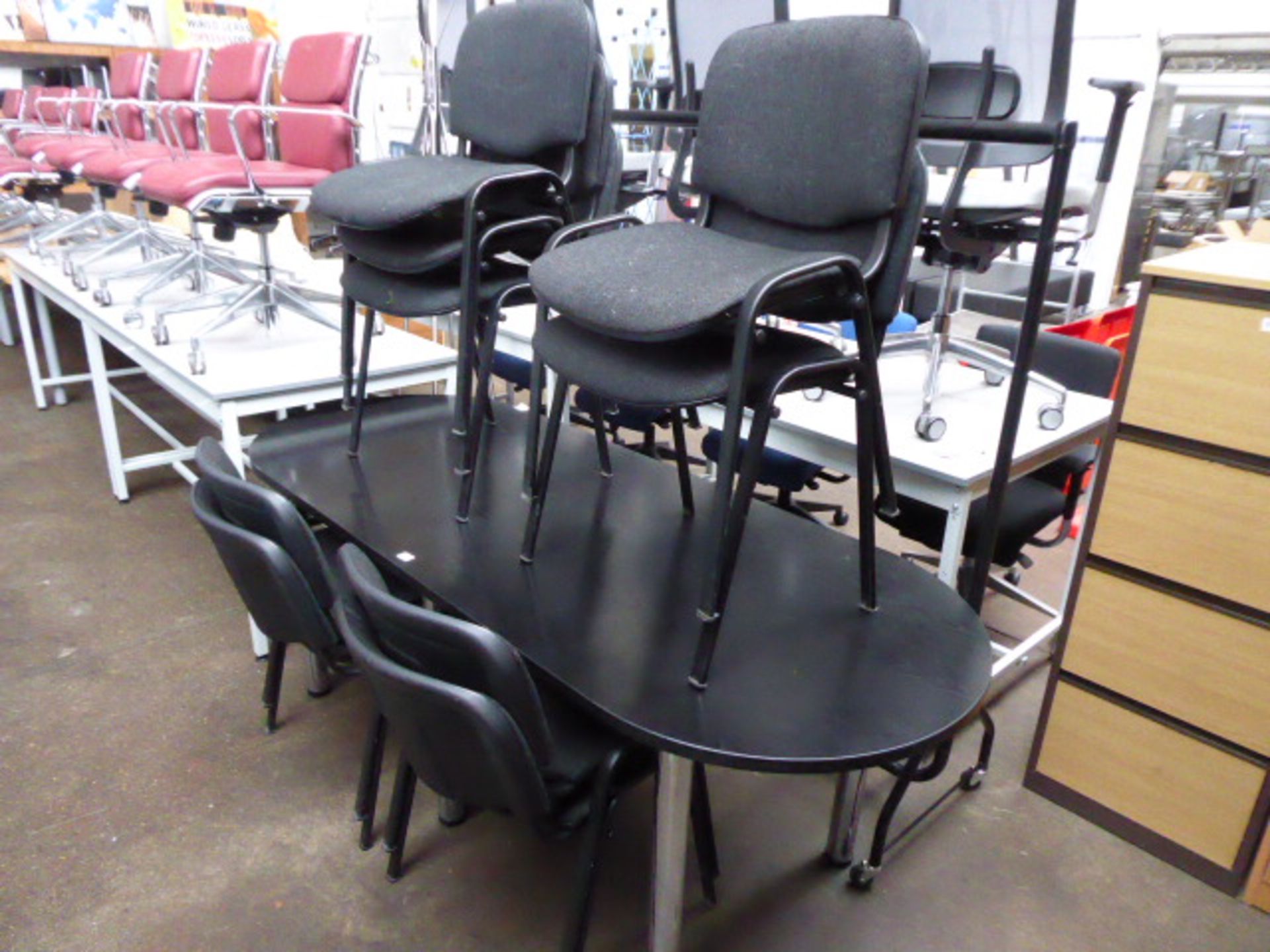 200 cm oval meeting table in black on chrome legs with a set of 9 matching charcoal cloth stacking