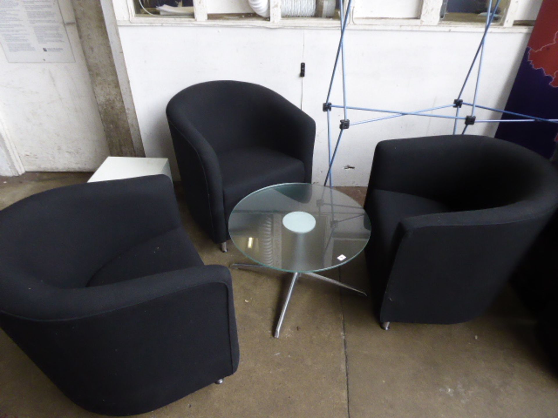 3 Orange Box black cloth tub chairs with a low circular glass top coffee table