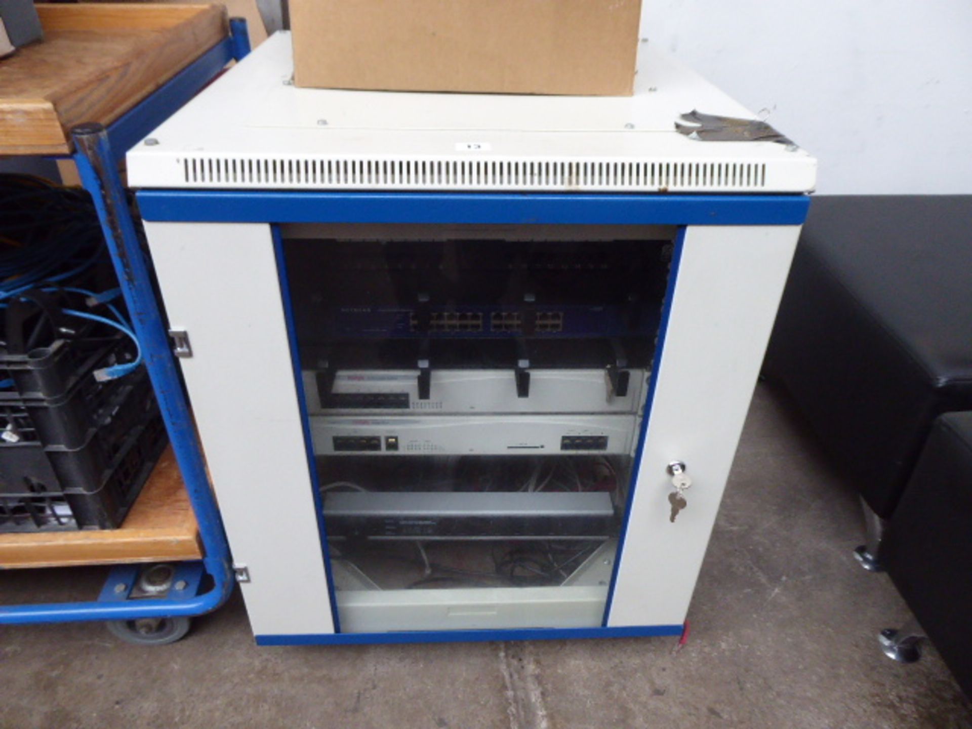 Small server cabinet with contents to inc. Netgear giga switch, 2 Avaya IP400 digital stations and a