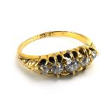 An early 20th century 18ct yellow gold ring set five graduated diamonds in a marquise shaped