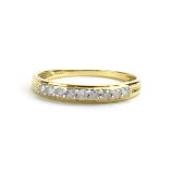 A 9ct yellow gold ring set nine brilliant cut diamonds in an online setting by Jacques Christie,
