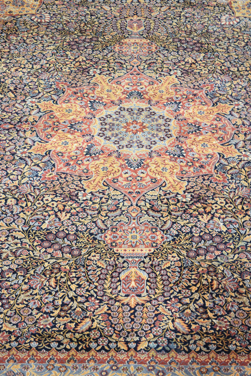A 20th century carpet with a red ground and floral sprays, - Image 2 of 2