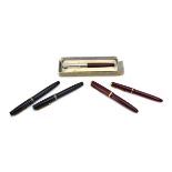 A pair of lady's and gentleman's Parker pens in red with 14ct gold nibs,