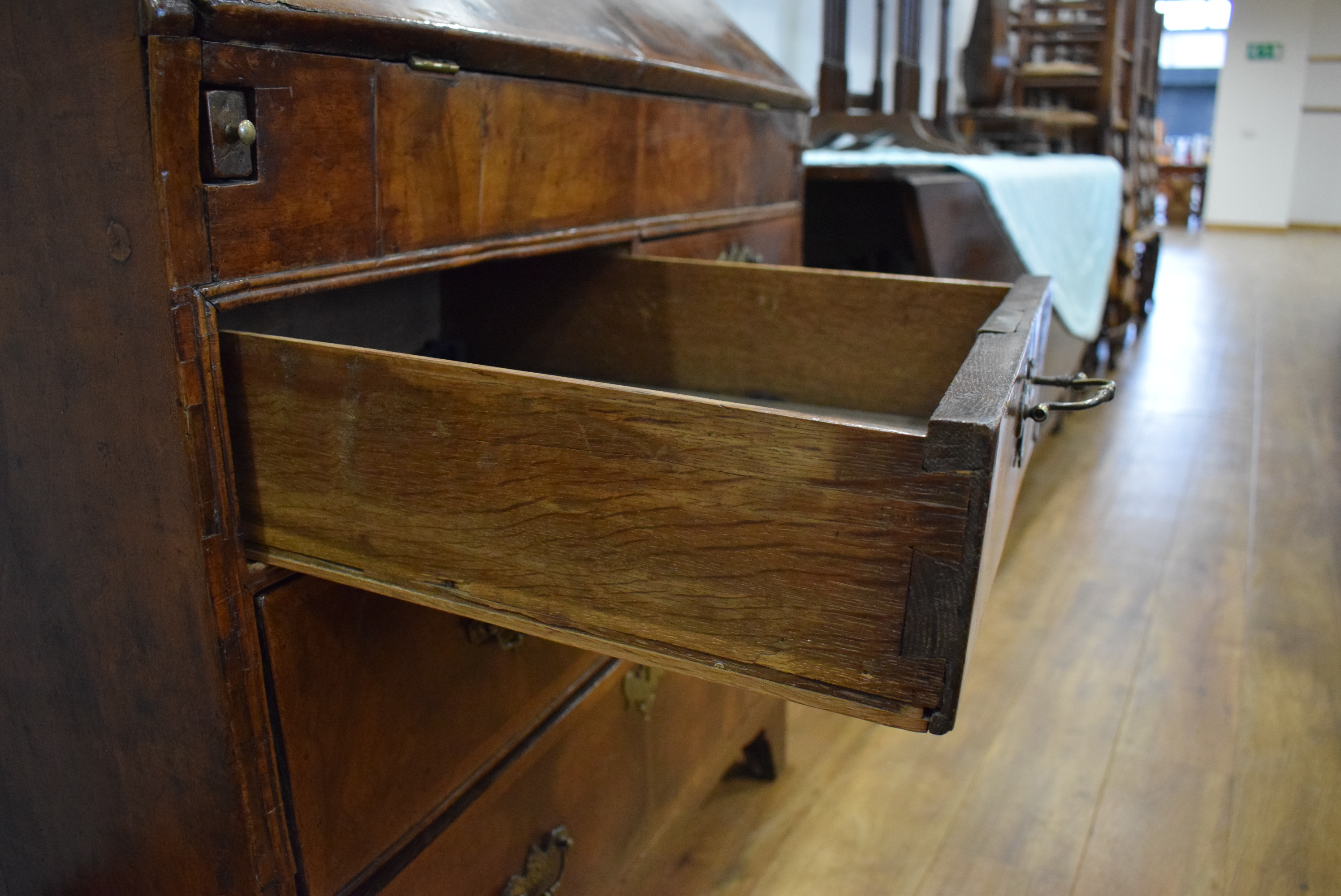 A George I/II walnut and feather crossbanded bureau, the fall front enclosing a fitted interior, - Image 49 of 55